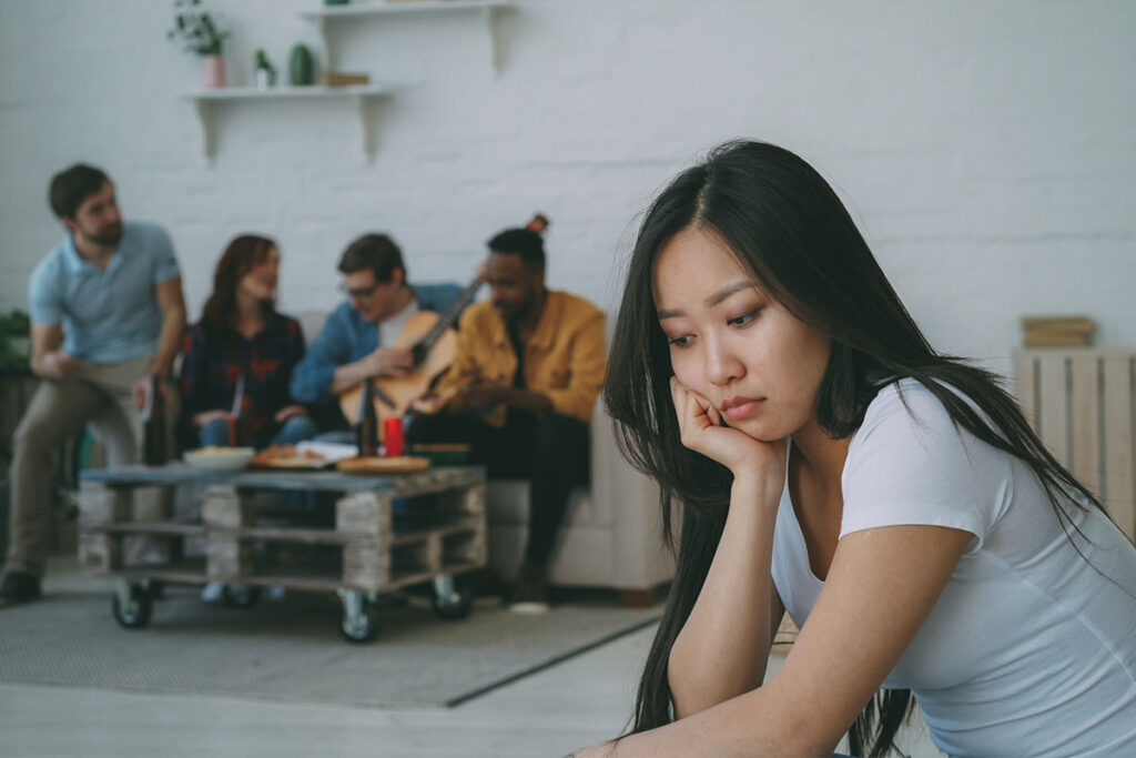 A young woman sits alone